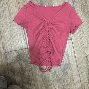 This is a pink that can be turned into cropped or be warn as a cute tee